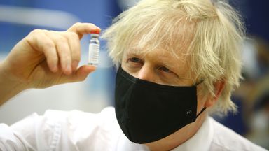 Prime minister Boris Johnson holding a vial of the Oxford/Astra Zeneca Covid-19 vaccine as he visits a vaccination centre at Cwmbran Stadium in Cwmbran, south Wales. Picture date: Wednesday February 17, 2021.